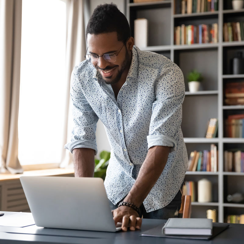 Man happily looking at a computer.